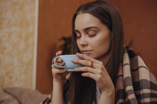 istock Tranquil young female enjoying hot tea at home 1445127069