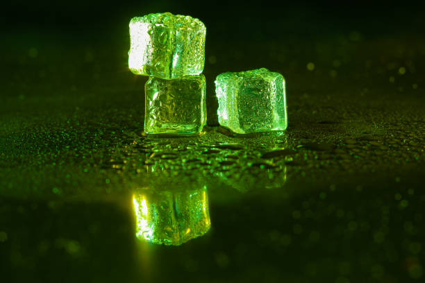 istock Green ice cubes on black background. 1445127125