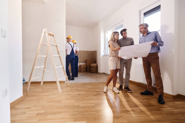 istock Couple working on plans with an architect during home renovation process. 1445127150
