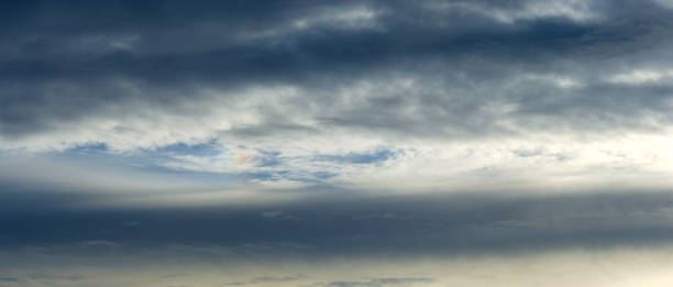 istock Dark rain clouds and morning sun. 1445128322