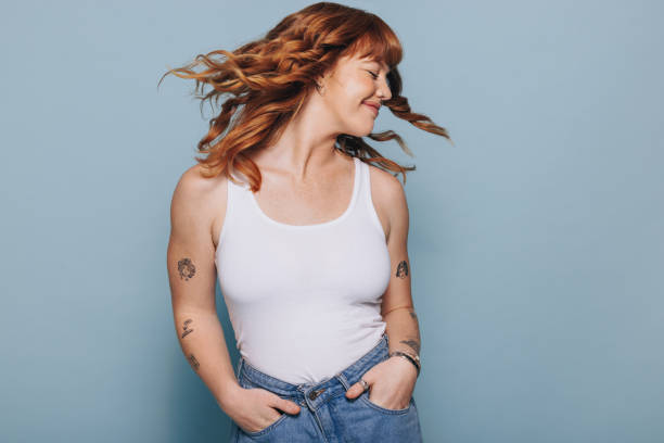 istock Young woman flipping her ginger hair in a studio 1445128343