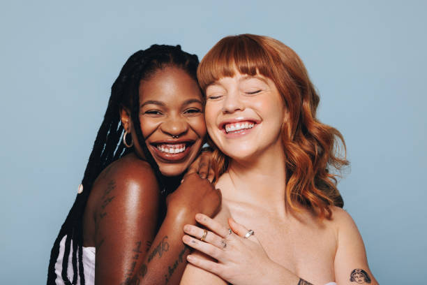 istock Cheerful young women with different skin tones smiling while standing together 1445128402