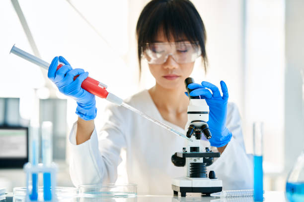 istock Female scientist making microbiology research using pipette, flask and test tubes working in modern chemical lab 1445128648