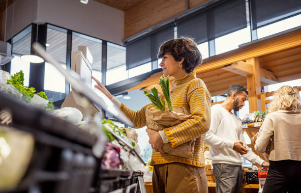 Small group of people shopping in the supermarket for groceries stock photo