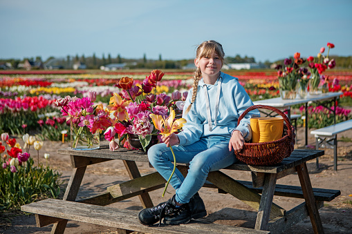 Farmer Daughter enjoying some free time in a colourful field of tulips on a lovely summer's day