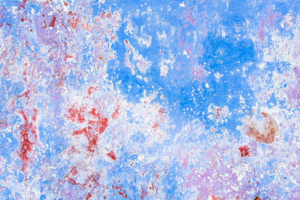 istock Weathered painted wall background texture. Old shabby peeled plaster wall with falling off flakes of colourful paint. 5 1445130364