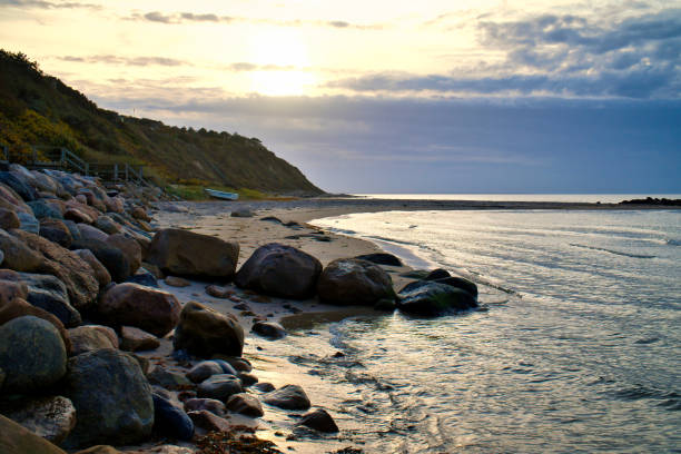 istock Sunset on the Danish coast. Beach, waves. Hill with trees in background. Landscape 1445130902
