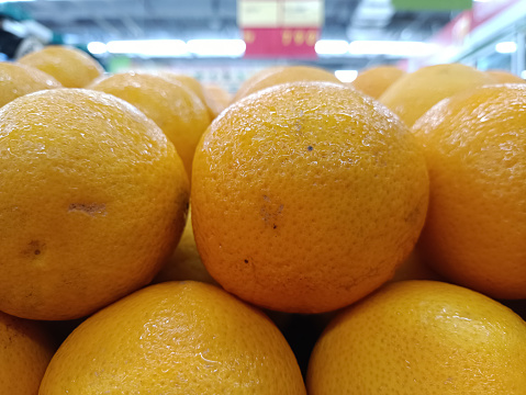 fresh sunkiss oranges neatly arranged in a fruit shop, fresh yellow color