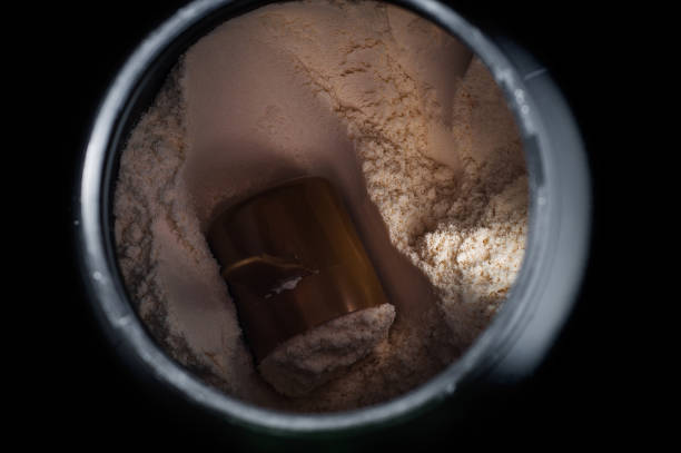 istock Black plastic jar with a sports supplement protein. On a black background. 1445133248