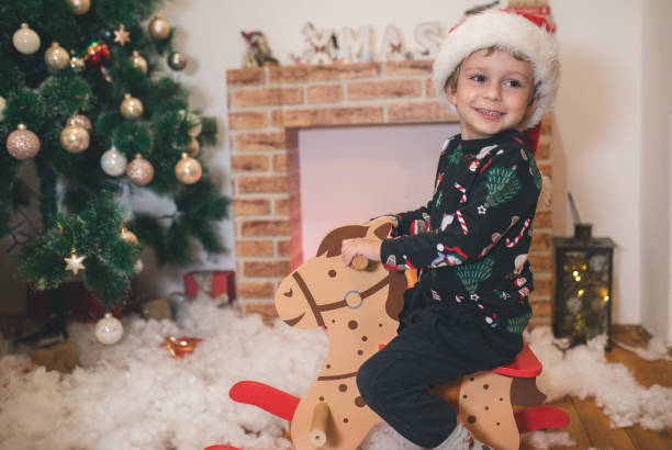 istock Happy Kid front of Christmas Tree 1445134776