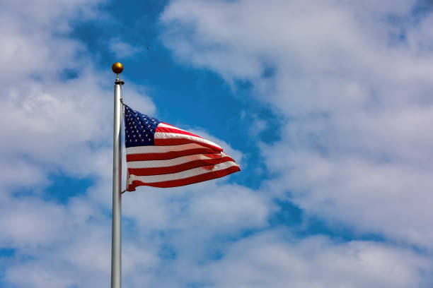 istock American Flag on a flagpole flying in the wind 1445134853