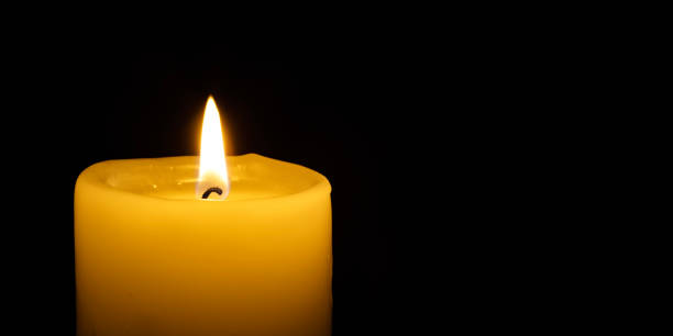 istock a burning candle on the black backgrounds 1445134887