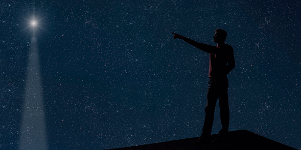 dad is on the roof at night and look at the christmas night sky