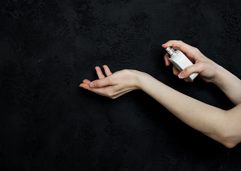 woman using perfume. lady applying spray