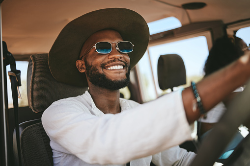 Travel, road trip and happy black man driving a caravan on a summer vacation, journey or adventure. Happiness, freedom and African guy with a smile on a drive to a holiday destination in South Africa