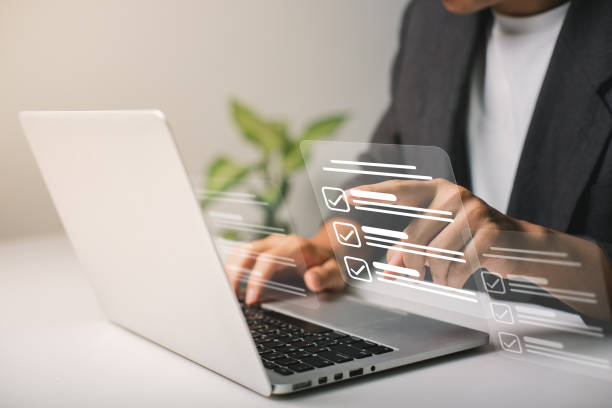 istock Businessmen use laptops to searching, managing and access information  in files online document database, for efficient archiving and company data. Document Management System (DMS) concept. 1445137873