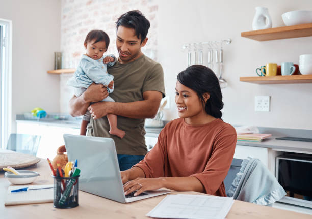 internet, famiglia e genitori che fanno ricerche sulla sindrome di down con il bambino su un laptop nella loro casa. madre e padre con il sorriso per il bambino e lavorando sulle tasse o sul budget finanziario sul computer - domestic life mother baby multi ethnic group foto e immagini stock