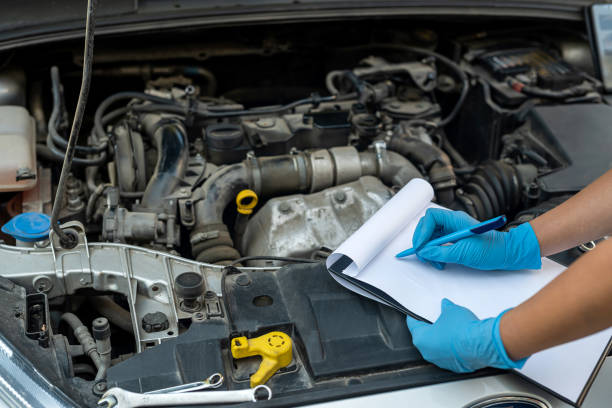 istock experienced female mechanic is servicing a car in her workshop. 1445138959