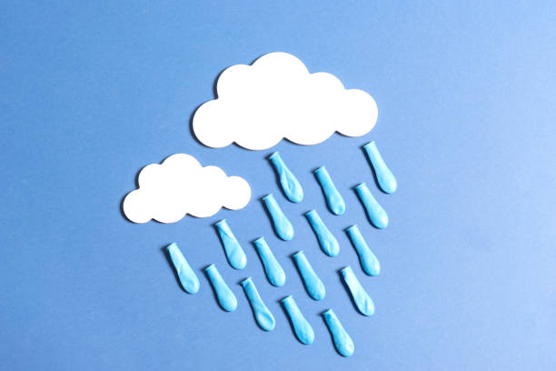 istock rain with white clouds and drops made with balloon, on blue background 1445139479