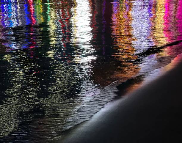 istock Night sea illuminated lights reflections on dark water. 1445141266
