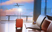 istock Travel concept with orange luggage in the airport terminal waiting area, summer vacation concept, traveling and enjoying concept 1445142001