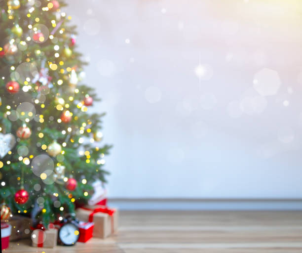 istock Christmas background with an elegant Christmas tree with gifts. blurred lights. 1445142011