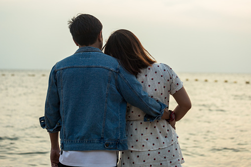 Asian couple on the beach travel and resting together with romance love