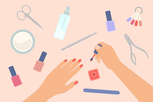 Nail Care Concept. Manicured Female Hands And Applying Nail Polish On Fingernails. Manicure Equipments On Table
