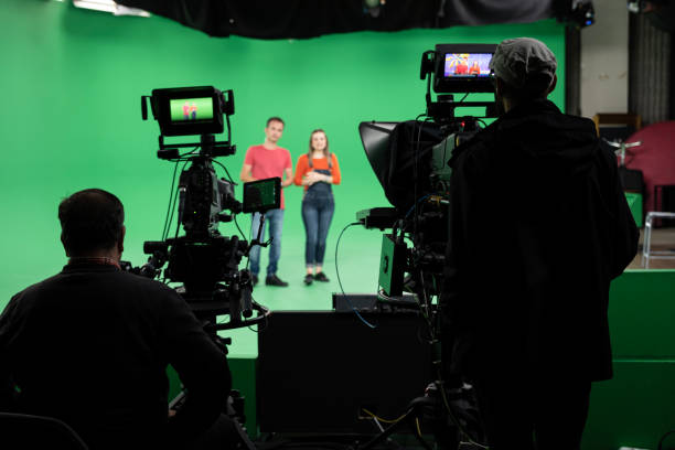 Lights.. Camera.. Action! Woman and Man anchor reporting news in studio. Film and Tv industry. Chroma Key, Studio Shot, Presenter, Television Industry, Movie Camera film set stock pictures, royalty-free photos & images