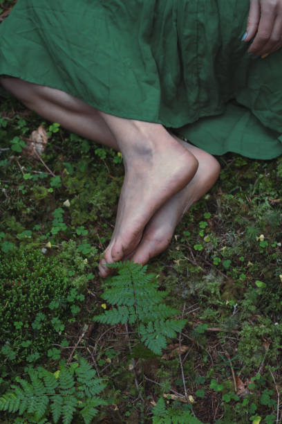 istock Close up feet on green forest ground concept photo 1445147520