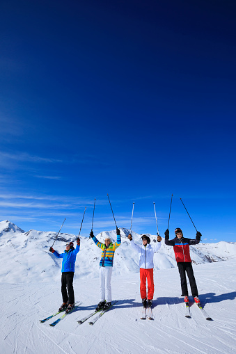 Friends Senior group , Men snow skier skiing, enjoying on sunny ski resorts. Skiing  against blue sky.