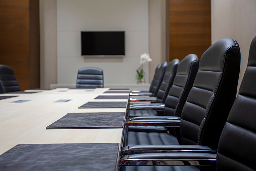 Image of aligned chairs in meeting room