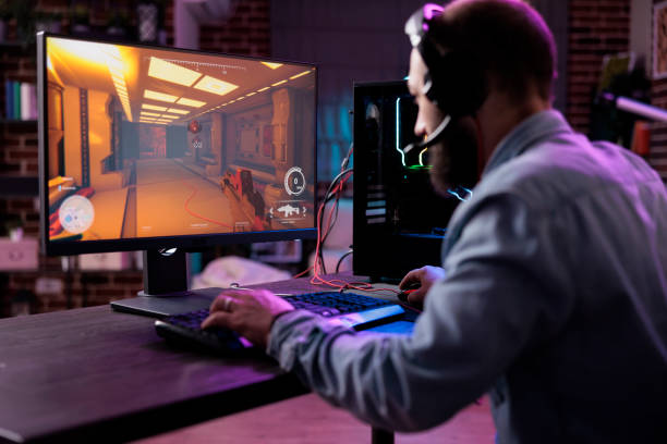 istock Male streamer playing online video games on computer 1445148355
