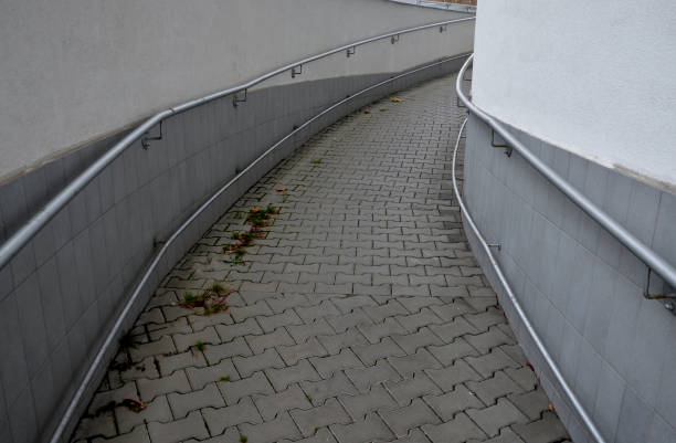 istock railing with two handrails. made of galvanized steel prisms. the lower railing is a protection against wheelchairs. ramp for the immobile in the housing estate, stainless steel, staircase, ramp 1445150662