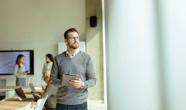 istock Young modern businessman using digital tablet in the office 1445153042