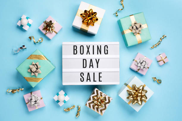 istock White Lightbox and Holiday Festive Gift Boxes on Cyan Blue Background. 1445153256