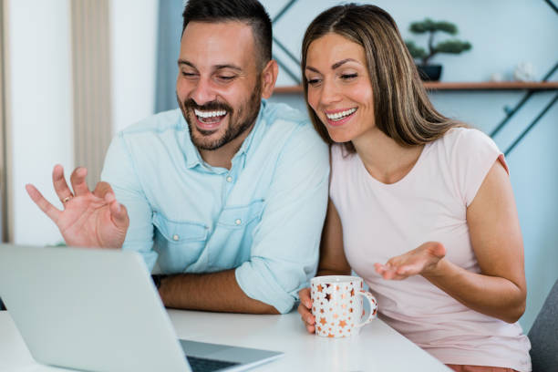 istock Cheerful couple having video call at home. 1445153527