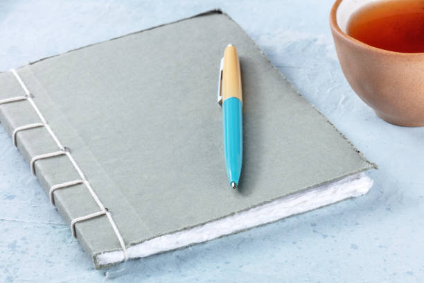 istock A diary. A paper journal with a pen and a cup of tea 1445156250