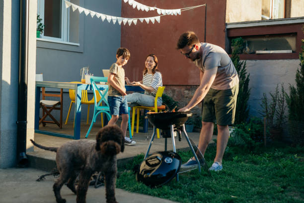 istock family preparing fire for barbecue in home backyard 1445156415