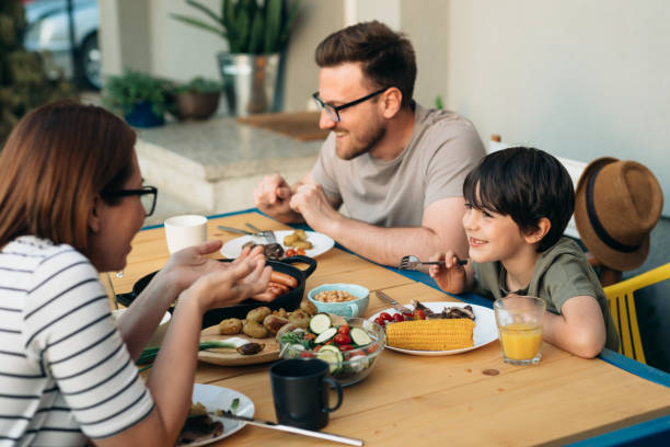 istock family eats together outside in home backyard 1445156452