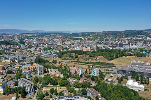 Renens is a municipality in the canton of Vaud and a suburb of the city of Lausanne. The image shows several residential buildings, captured during summer season.