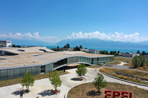 École Polytechnique Fédérale de Lausanne (EPFL) also known as Swiss Federal Institute of Technology Lausanne. The image shows the university campus with some new buildings captured on a sunny day during summer season.