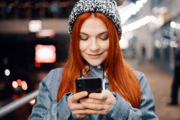 istock Woman using mobile phone outdoors 1445157591