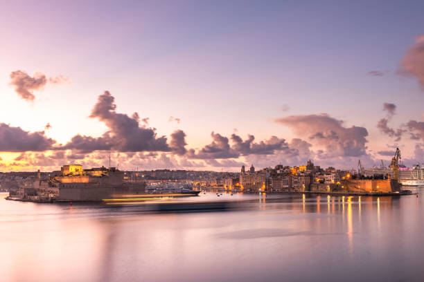 Illuminated skyline of Senglea at sunrise,Malta. One of Three Cities in Grand Harbour stock photo