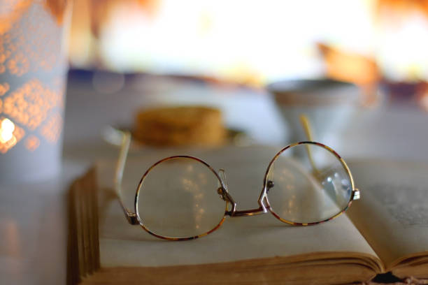istock Tea, Cookies, Candle, Book, Glasses and Fireplace 1445158471