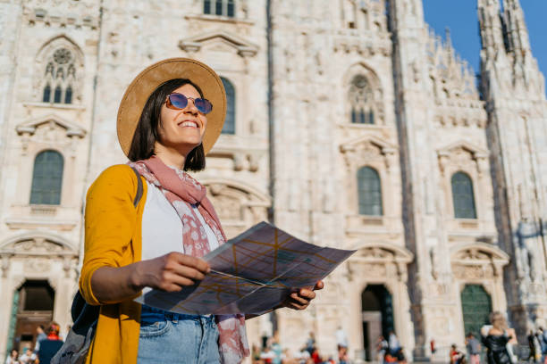 istock Young Female Using A Map In Front Of Cathedral In Milan 1445158541