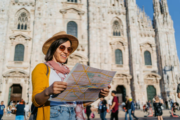 istock Young Female Using A Map In Front Of Cathedral In Milan 1445158580