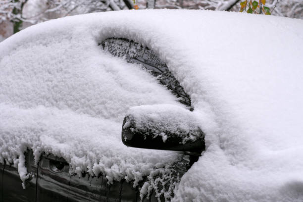 istock Dark passenger car covered snow 1445158637
