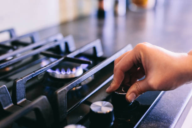 istock Hand turning on gas burner on kitchen stove top 1445161875