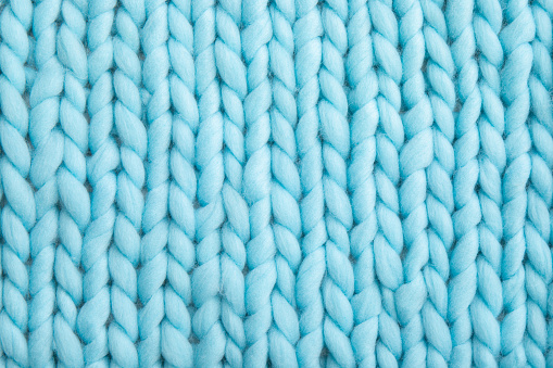 Primer plano por encima de la vista de lana suave azul claro de lana de punto de lana de fondo. photo